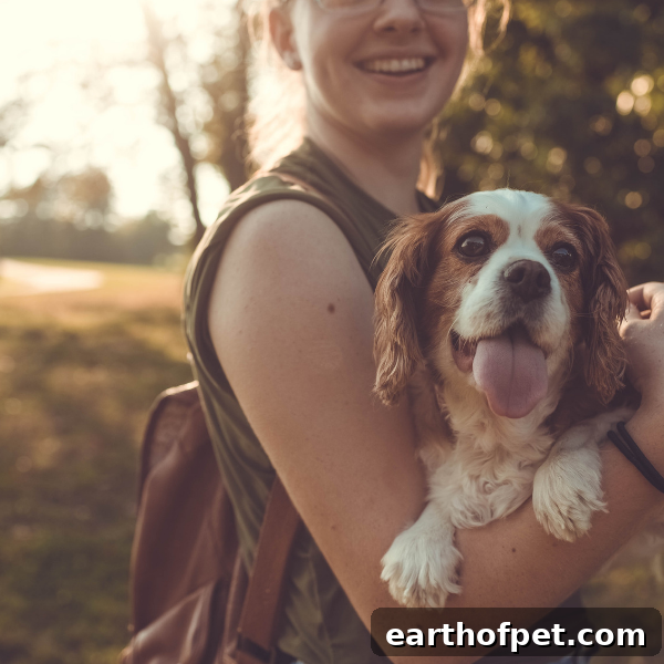 woman hiking with Cavalier King Charles Spaniel
